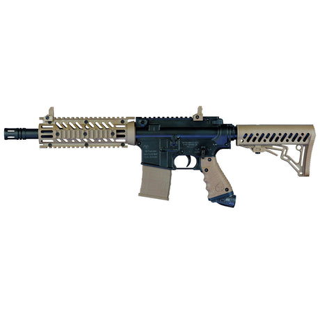 Left side Tippmann TMC black tan paintball marker with banking dummy magazine on a white background